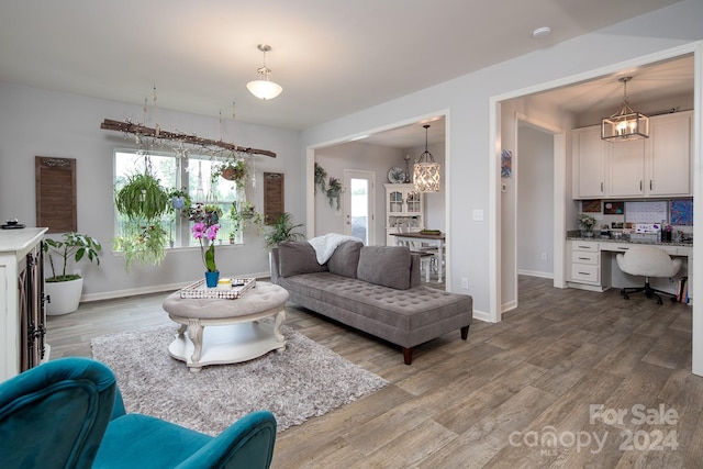 living room featuring built in desk and wood-type flooring