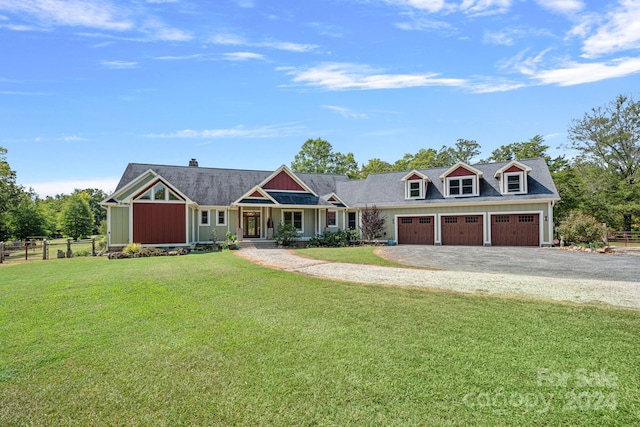 view of front of property featuring a porch, a garage, and a front lawn