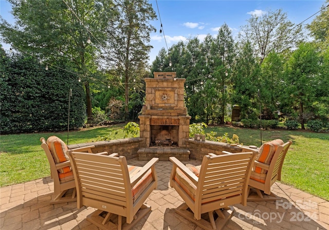 view of patio featuring an outdoor stone fireplace