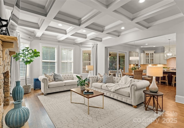 living room featuring beamed ceiling, coffered ceiling, hardwood / wood-style floors, and crown molding