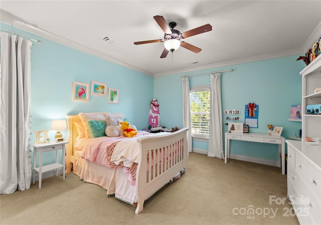 carpeted bedroom featuring crown molding and ceiling fan