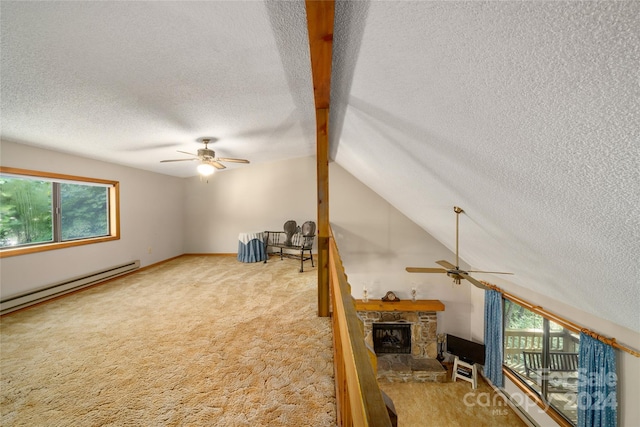 unfurnished living room featuring a textured ceiling, ceiling fan, vaulted ceiling with beams, a stone fireplace, and light colored carpet