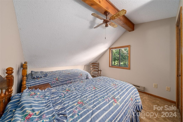 carpeted bedroom featuring lofted ceiling with beams, a textured ceiling, baseboard heating, and ceiling fan