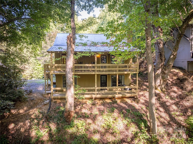 back of property featuring a wooden deck