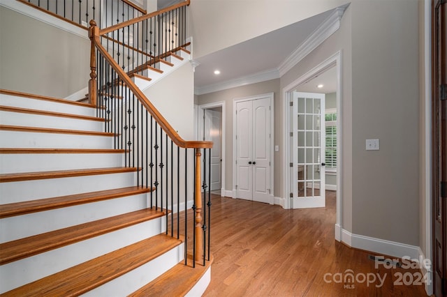 entrance foyer featuring crown molding and hardwood / wood-style floors