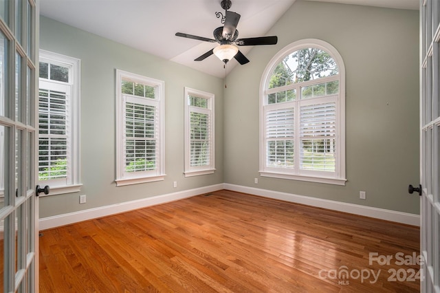 unfurnished room featuring lofted ceiling, light hardwood / wood-style flooring, and ceiling fan