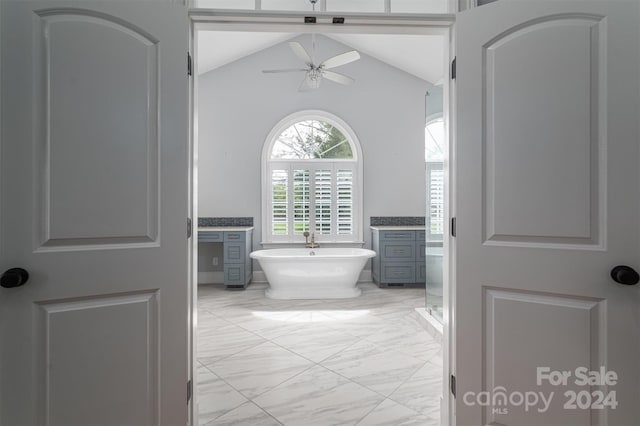 bathroom with vanity, shower with separate bathtub, ceiling fan, and vaulted ceiling