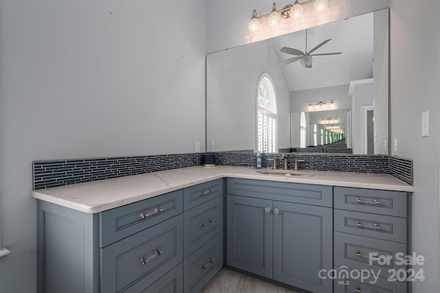 bathroom with vanity, backsplash, and ceiling fan