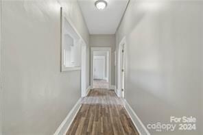 hallway with hardwood / wood-style flooring