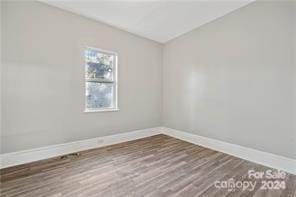 empty room featuring dark hardwood / wood-style flooring