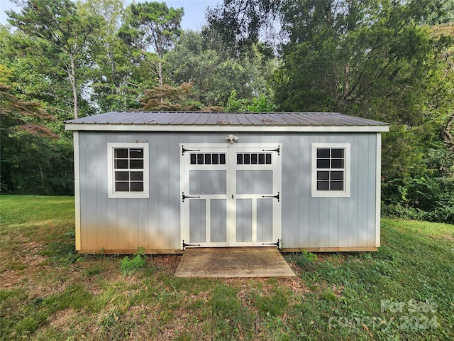 view of outbuilding with a yard