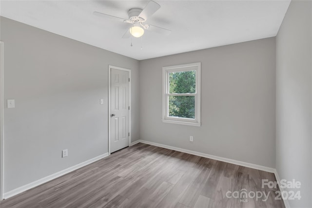 spare room with ceiling fan and light hardwood / wood-style floors