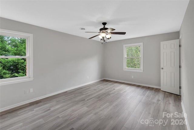 empty room featuring light wood-type flooring and ceiling fan