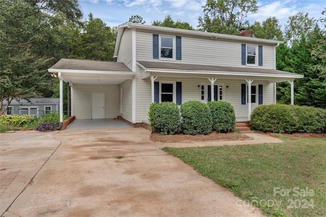 front facade with a front lawn and covered porch