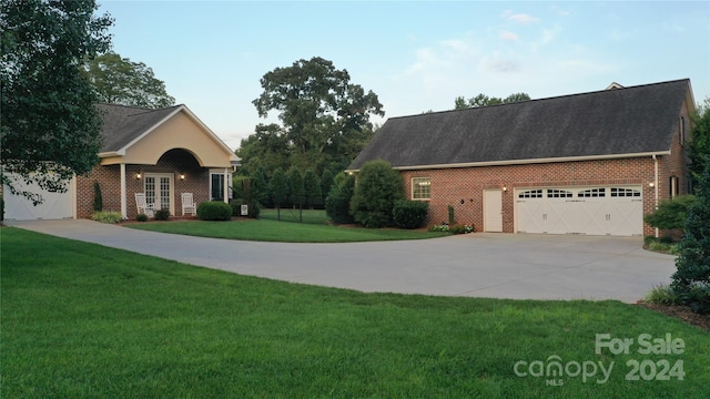 view of front of property with a garage and a front yard