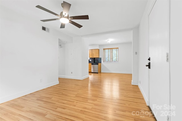 unfurnished living room with light wood-type flooring and ceiling fan