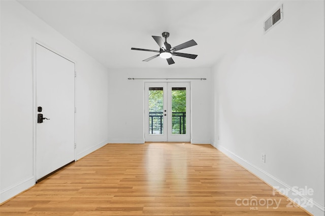 spare room with french doors, ceiling fan, and light hardwood / wood-style flooring