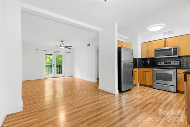 kitchen with backsplash, french doors, light hardwood / wood-style flooring, stainless steel appliances, and ceiling fan