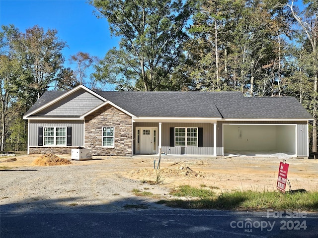 view of front of house featuring a porch and a garage