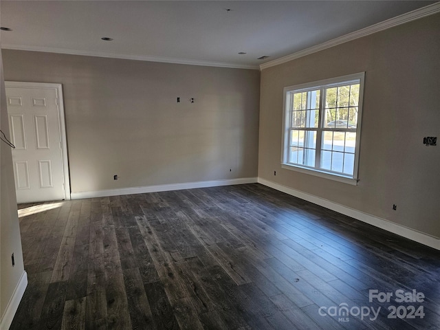 spare room with dark hardwood / wood-style floors and ornamental molding