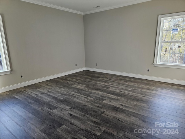 unfurnished room with ornamental molding and dark wood-type flooring