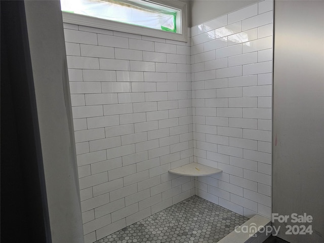 bathroom with a tile shower