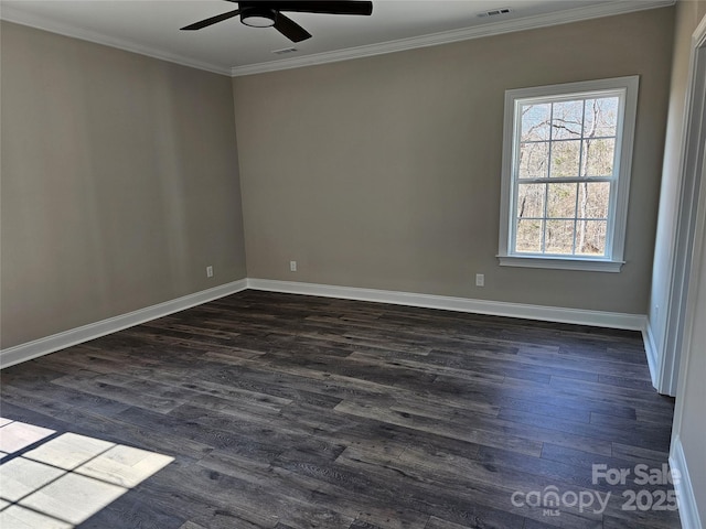 spare room featuring crown molding, dark wood-type flooring, and ceiling fan