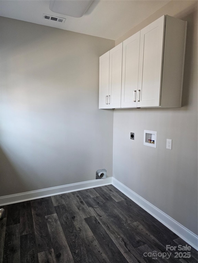laundry room with electric dryer hookup, hookup for a washing machine, dark hardwood / wood-style floors, and cabinets