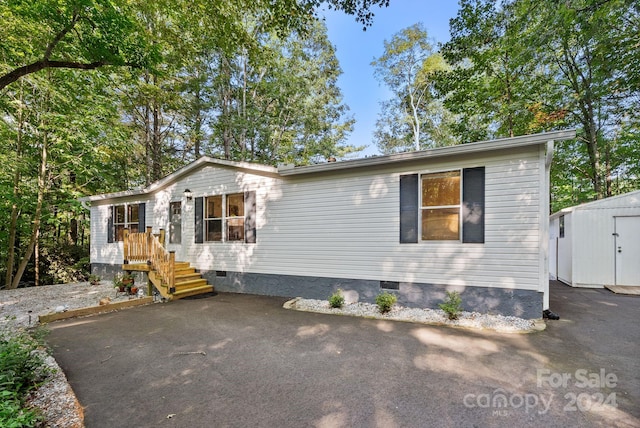 manufactured / mobile home with a storage shed