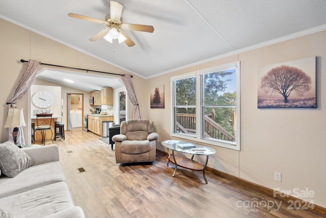 living room featuring ceiling fan, a textured ceiling, vaulted ceiling, hardwood / wood-style flooring, and ornamental molding