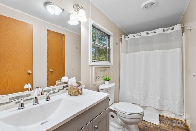 bathroom featuring hardwood / wood-style floors, vanity, toilet, and a shower with curtain