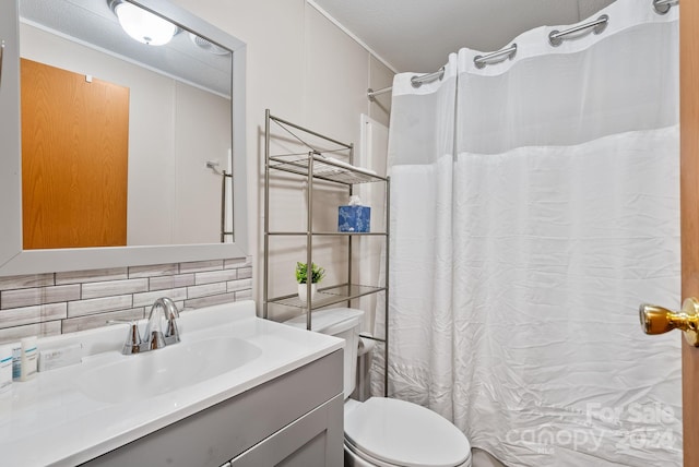 bathroom with decorative backsplash, toilet, a textured ceiling, and vanity