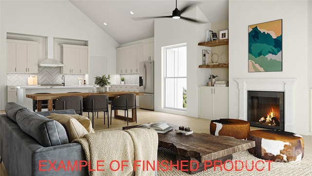 living room with sink, light hardwood / wood-style floors, high vaulted ceiling, and ceiling fan