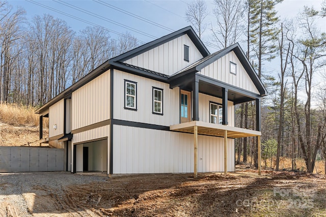 view of property exterior with a garage and a balcony