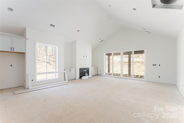 unfurnished living room featuring high vaulted ceiling