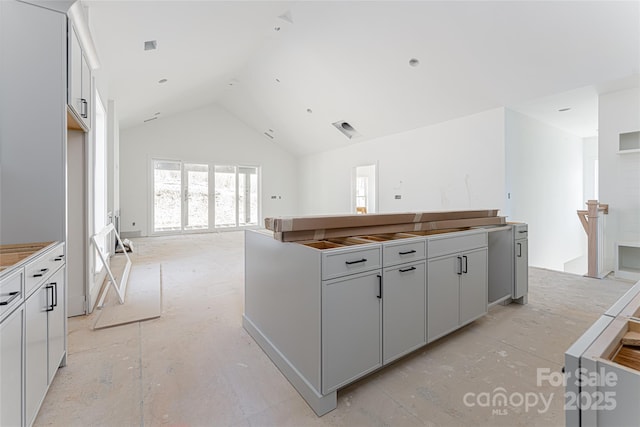 kitchen with gray cabinets and high vaulted ceiling