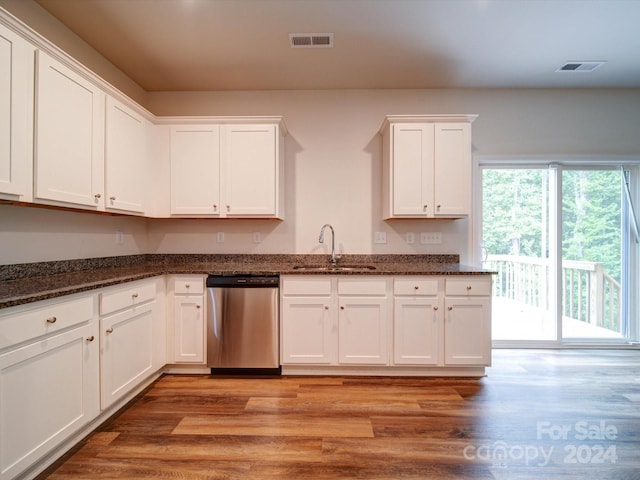 kitchen featuring white cabinetry, sink, light hardwood / wood-style floors, dishwasher, and dark stone countertops