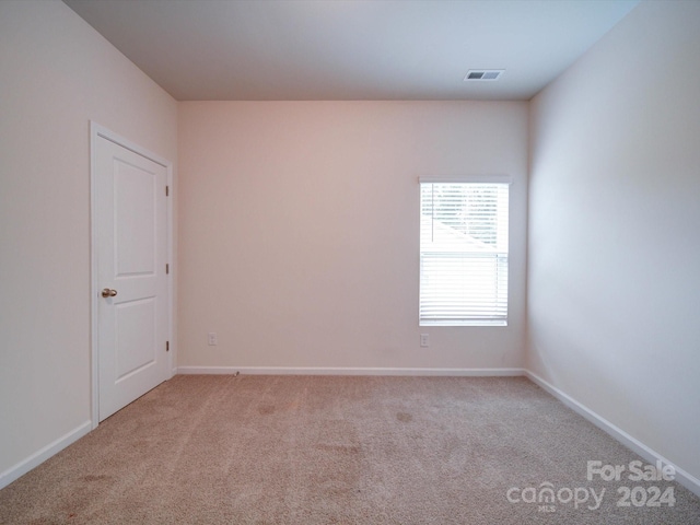 empty room featuring light carpet