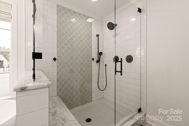 bathroom featuring a tub, a stall shower, and ornamental molding