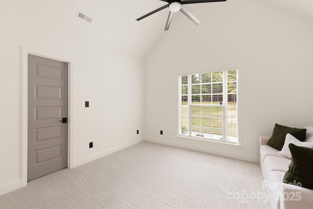 interior space with vaulted ceiling, baseboards, visible vents, and ceiling fan