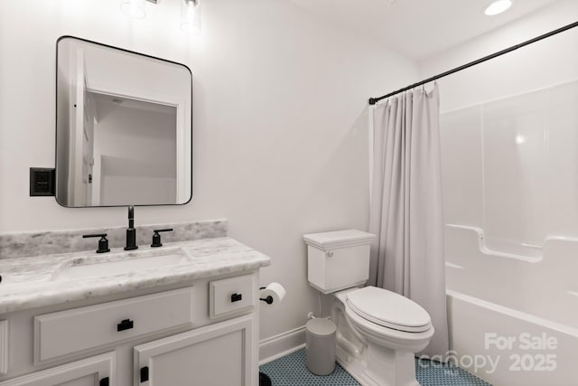 bathroom featuring vanity, toilet, shower / bathtub combination with curtain, and baseboards