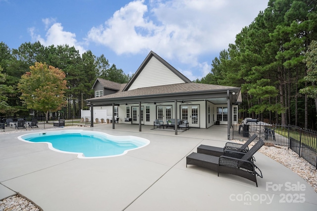 view of pool with french doors, fence, a fenced in pool, and a patio area