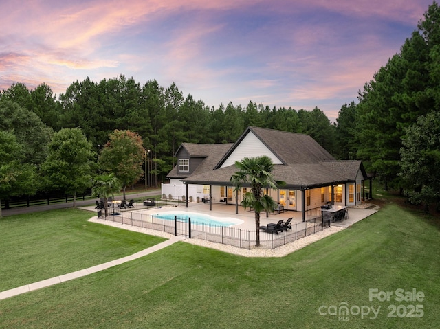 view of swimming pool with fence, a yard, a grill, a fenced in pool, and a patio area