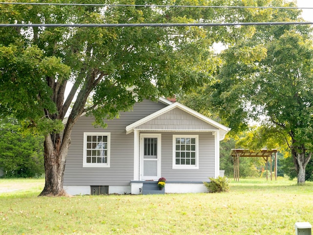 view of front of home with a pergola and a front yard