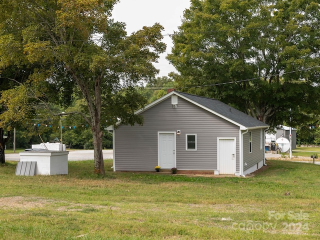 view of outbuilding featuring a lawn