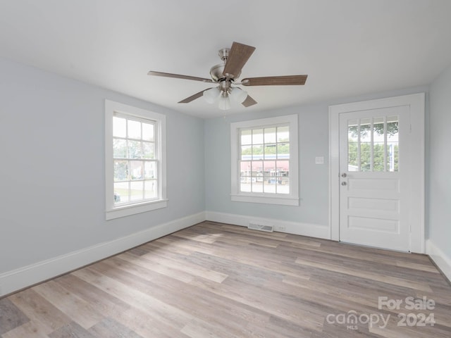 foyer entrance featuring plenty of natural light, ceiling fan, and light hardwood / wood-style floors