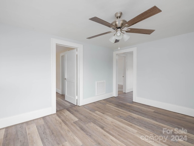 spare room with ceiling fan and light hardwood / wood-style floors