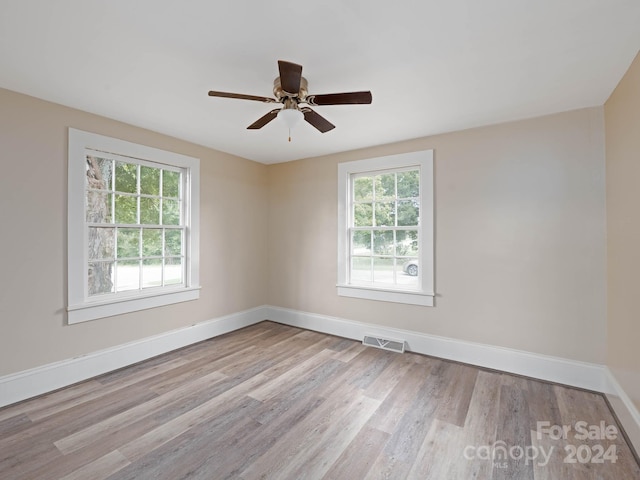 empty room featuring ceiling fan and light hardwood / wood-style floors