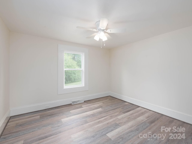 unfurnished room with light wood-type flooring and ceiling fan