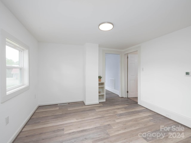 spare room with light wood-type flooring